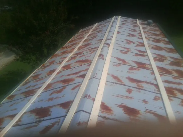 Rusted metal roof panels with new wood purlins before replacement — Storm Damage Roof Repair in Robstown by Roofing Brothers