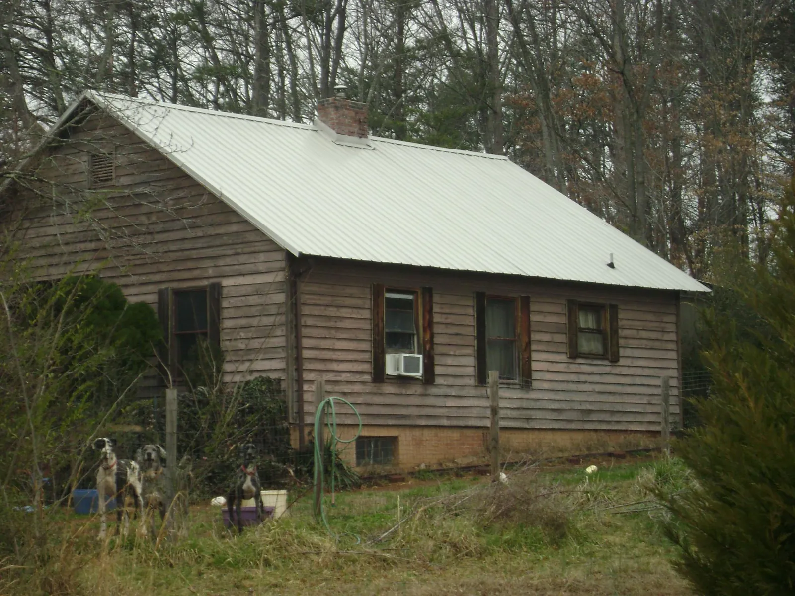 White metal roof on an old wood sided farmhouse, from a Metal Roof Installation job in Robstown